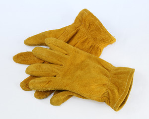Worn, suede leather work gloves isolated on white