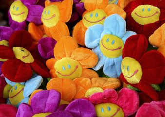 Fototapeta na wymiar smiling colourful fabric flowers