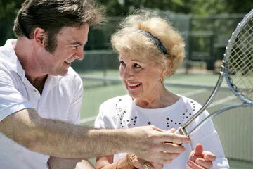 Foto op Canvas  tennis pro gives pointers to older lady © Lisa F. Young