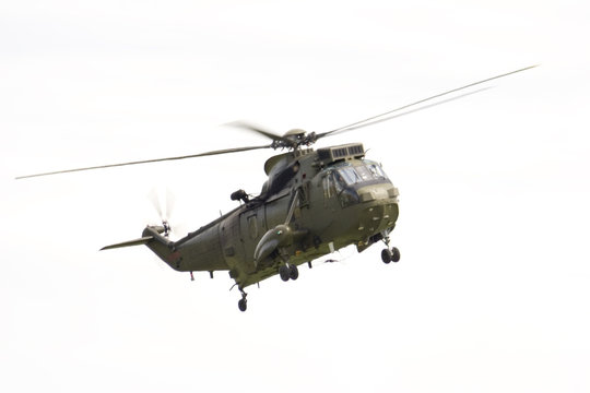 A Royal Air Force Sea King military Helicopter against a white background.