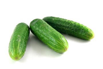 three cucumbers isolated on white with a bit of shadow