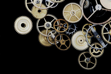Macro of tiny watch cogs on a black background