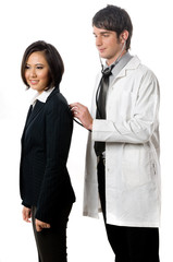 A young male doctor examines a female patient