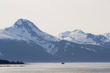 Snow capped mountains taken  from the water near Juneau,
