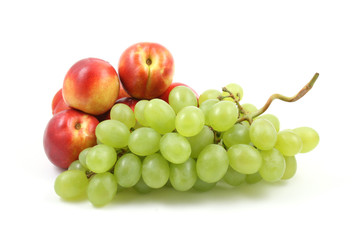 bunch of fresh green grapes and nectarines isolated on white