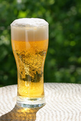 Beer mug at the table close-up, background is out of focus