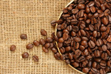 Plate of coffee beans close-up over burlap