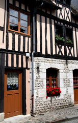 Fototapeta premium House in Normandy, France with pretty flower filled window boxes