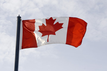 Canadian flag waving in the breeze in the sunshine