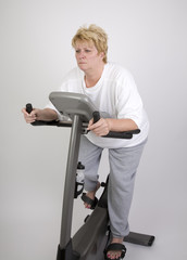 woman looking bored on exercise bike