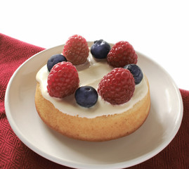 small cake dessert  with raspberries and blueberries