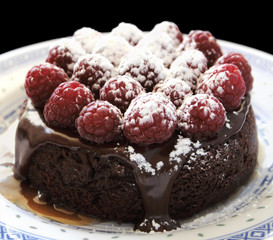 small chocolate cake with raspberries and caramel