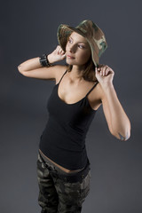 Brunette military girl with a camouflage hat and black shirt