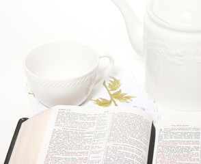 Open Bible, tea cup and tea pot