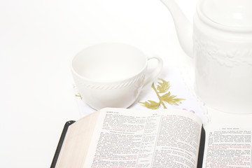 Open Bible, tea cup and tea pot