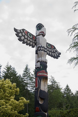 Bird carved atop a totem pole in Butchart Gardens