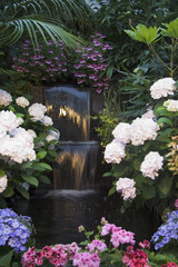 Small waterfall surrounded by plants in Butchart Gardens