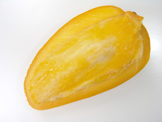 Sweet juicy champagne mango slice close-up with seed