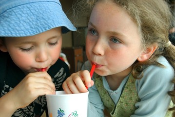 boy and girl sharing a drink