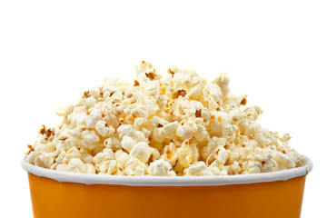 Detail of popcorn in a bucket over a white background