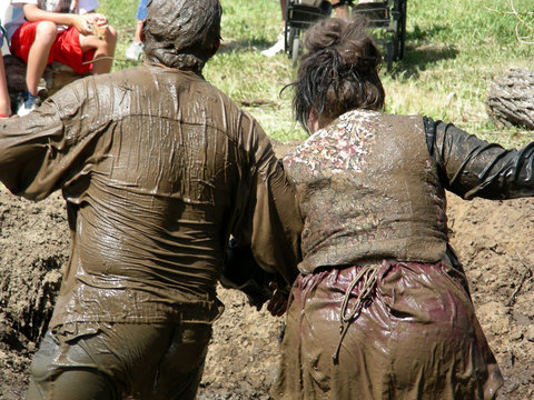 Couple competing in a mud wrestling contest at a local fair