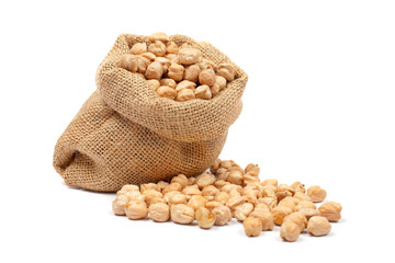 Burlap sack with chickpeas spilling out over a white background
