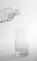 bottle water being poured into a glass