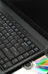 PC computer laptop with cd and rainbow prism reflection