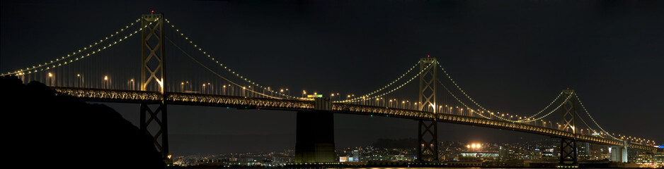 Bay Bridge at night with reflection in the water
