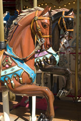 Fototapeta na wymiar Carousel with brown horse portrait