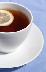 cup of tea with lemon on white