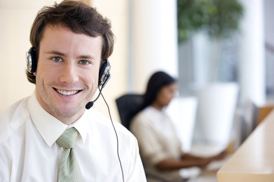 Young businessman with headset in office