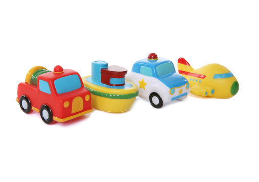 Colorful toy airplane, boat, fire truck, and police car