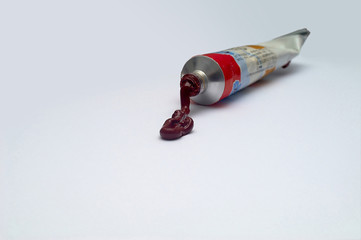 An image of a tube with spilled paint yt6