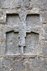 Cross in a wall. Monastery of Sant Pere in Camprodon, Catalonia