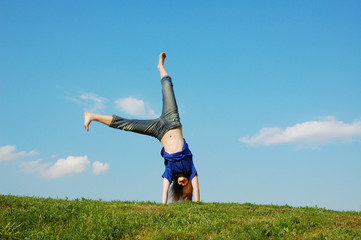 Cartwheel on meadow on a background blue sky