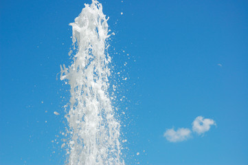 Fountain of water on a background blue sky