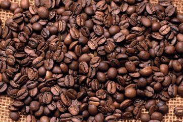 roasted coffee beans on a bag. vertical photo