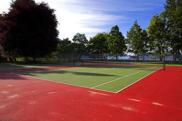 wide angle of colorful tennis court over blue sky