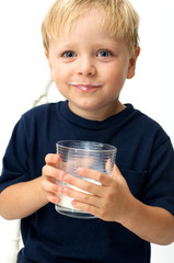 Boy with glass of milk posing with his white moustache