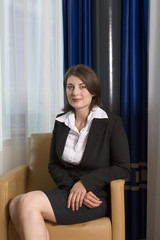 A young attractive businesswoman sitting in a chair 