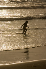 Fototapeta na wymiar Girl running in the ocean