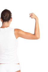 Beautiful woman flexing biceps - high key shot in studio