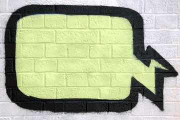 Graffiti thought bubble sprayed on a brick wall.