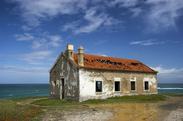 Fototapeta na wymiar Beautiful scene of an old abandoned house close to the coast