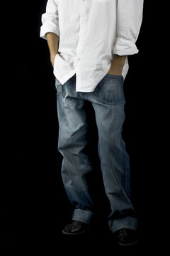 Picture of a boy on a black background with hands on the pockets