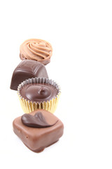 row of mixed chocolates isolated on white