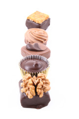 row of mixed chocolates isolated on white