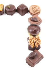 frame of mixed chocolates isolated on white