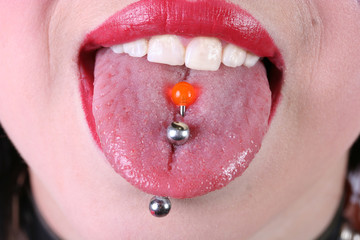 closeup tongue red piercing sphere lips mouth